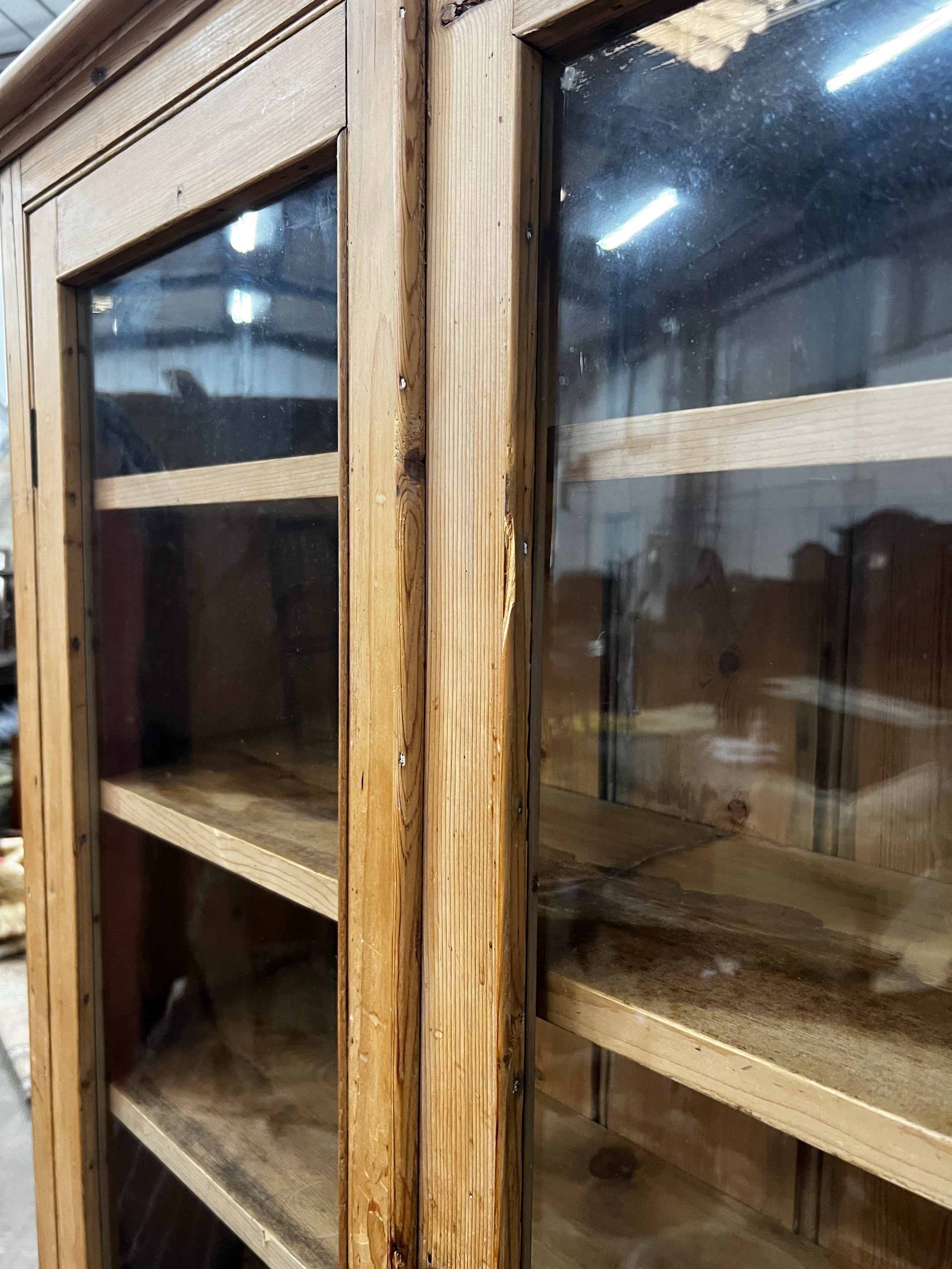 A Victorian glazed pine two door cabinet on stand, width 96cm, depth 27cm, height 182cm